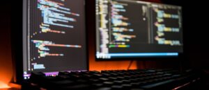 Picture of two computer screens showing code