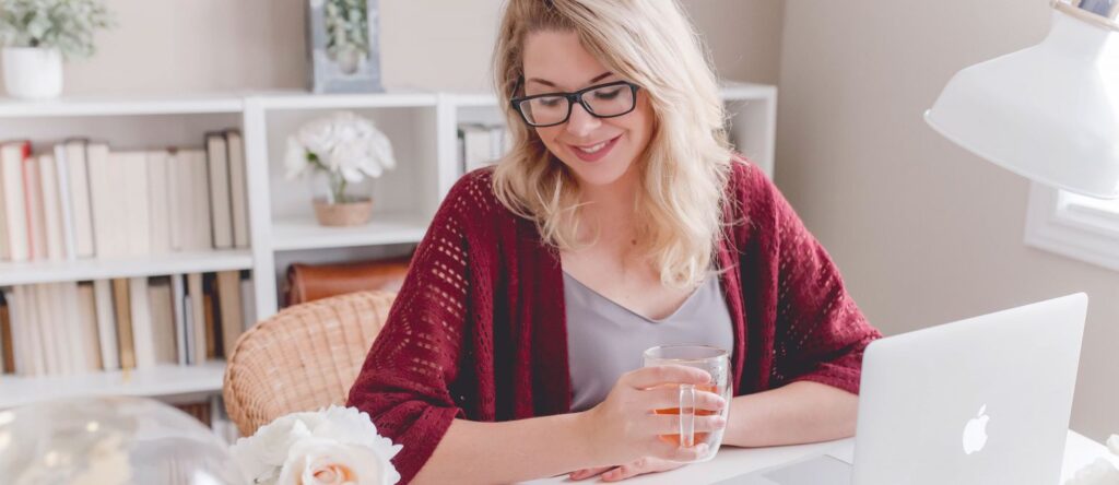 Picture of a lady working and drinking coffee