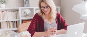 Picture of a lady working and drinking coffee