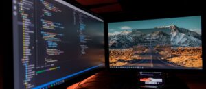 Picture of a code and output screen on two computer screens
